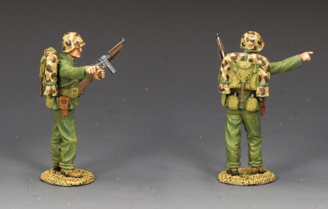 Pointing Marine 'Gunny'. Two toy soldiers in green camouflage uniforms with rifles on a gray background