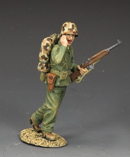 Shouting Marine Officer. Model soldier figure in military uniform with rifle on a gray background