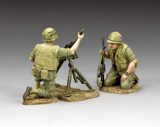 Two military miniature toy soldiers in military gear on a gray background