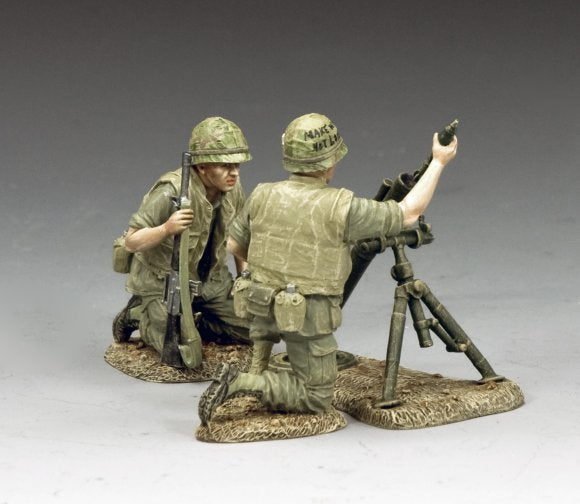 Marines Mortar Team. Two toy soldiers in military uniforms with weapons on a gray background