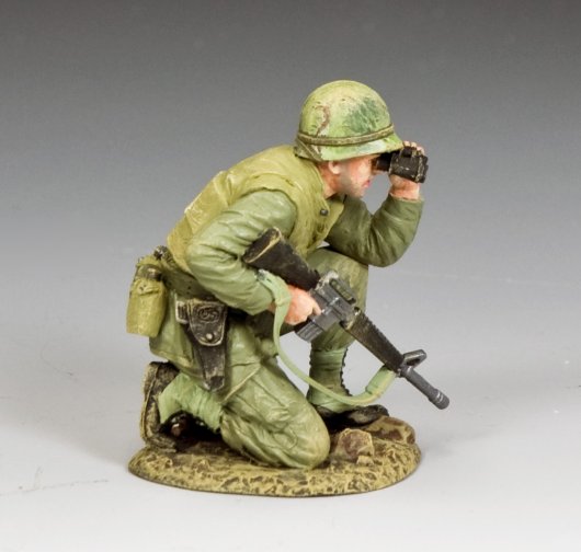 Model of a toy soldier in green military uniform with rifle and helmet, on gray background