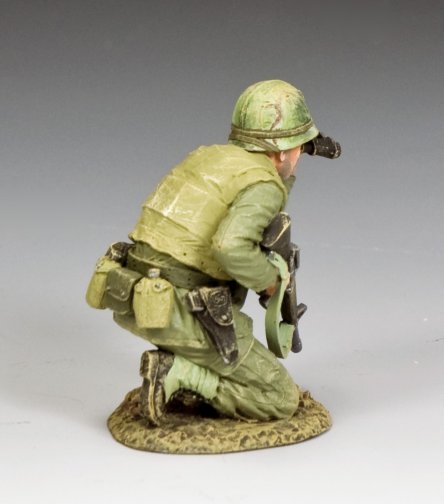 Model of a military miniature in green camouflage uniform on a gray background