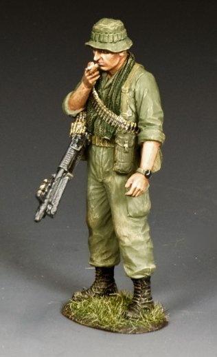 Military miniature of a soldier in military uniform with a rifle on a gray background