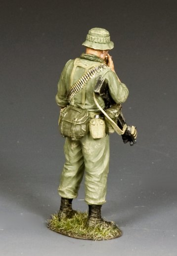 Model of a soldier in green uniform with equipment on a gray background