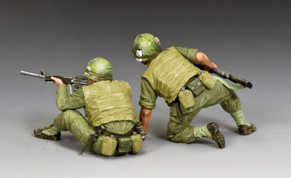 Two toy soldiers in green camouflage uniforms with rifles on a gray background