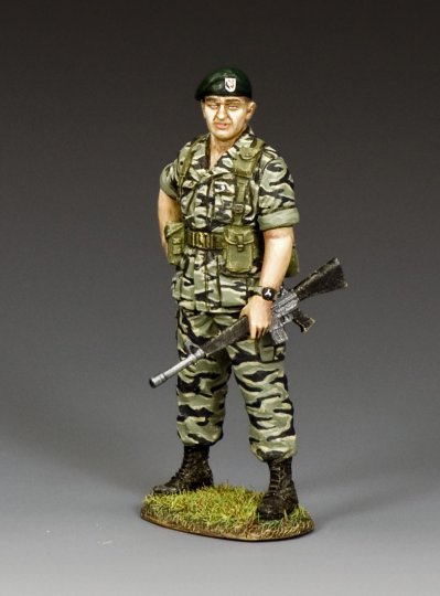 Green Beret Colonel in Tiger Stripes holding rifle.