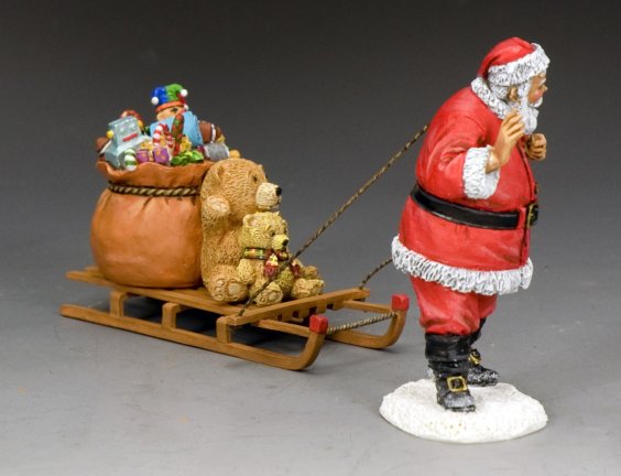 Santa Claus figurine pulling a toy-filled sled with teddy bears and a sack of gifts, hand-painted in matte finish.