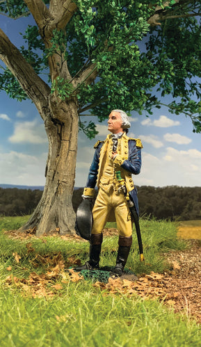 Collectible toy soldier miniature George Washington in a field by a tree.