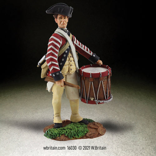 Collectible toy soldier miniature. Drummer in military uniform.