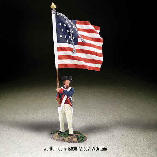 Collectible toy soldier miniature holding a U.S. Flag.