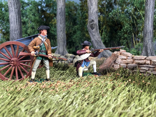 Two collectible toy soldier miniatures in a field with a cannon.