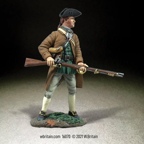 Collectible toy soldier miniature standing at the ready with musket.
