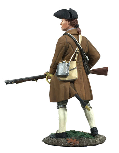 View from behind of collectible toy soldier miniature holding a musket.