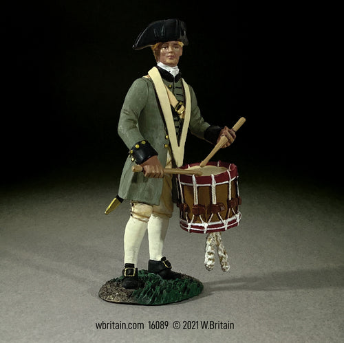Collectible toy soldier miniature holding a drum.