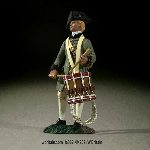 Collectible toy soldier miniature standing while playing a drum.