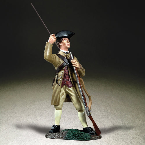 Collectible toy soldier miniature in colonial clothing loading a musket.
