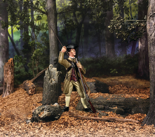 Toy soldier standing in a forest loading a musket.