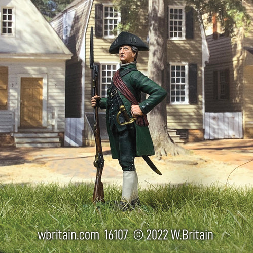 Collectible toy soldier miniture Major John Buttrick. He is standing in front of houses.