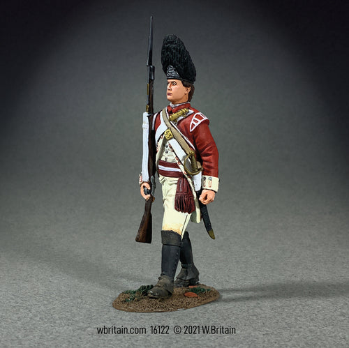 Collectible toy soldier miniature Grenadier NCO Marching. Soldier is in uniform and holding a musket with a bayonet.