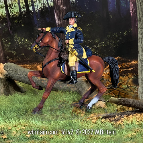 Collectible toy soldier on horseback in a forest.