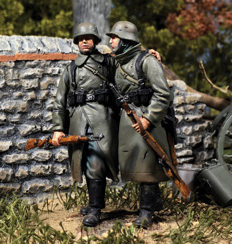 Toy soldier army men set German Helping Wounded Comrade in Greatcoat. They are in the forest.