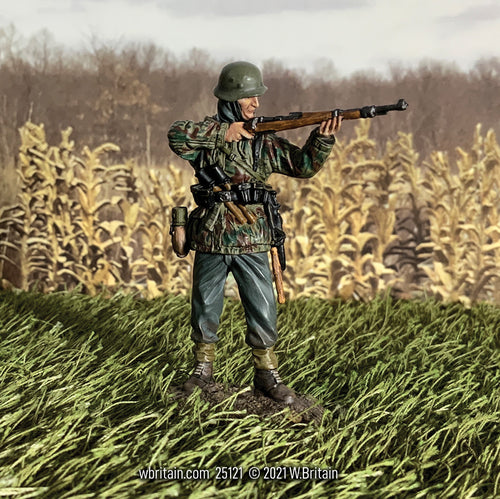 Toy soldier miniature German Grenadier in Parka Standing Firing 98k. On the battlefield.