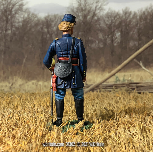Rear view off Collectible toy soldier miniature Captain George Armstrong Custer. Standing in a field.
