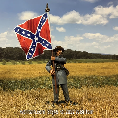 One toy soldier figurine holding confederate flag in a field.