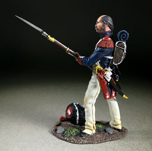 Collectible toy soldier miniature "Near Miss!" French Imperial Guard. Soldier holding musket and bayonet. He is wearing a blue jacket.