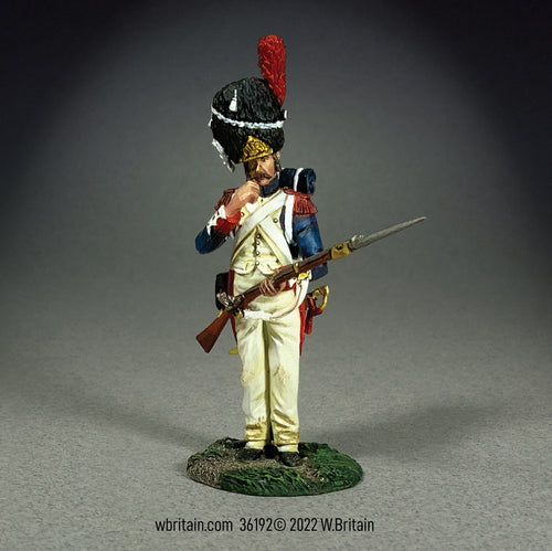 Collectible toy soldier miniature French Imperial Guard Tearing Cartridge. He is loading his musket.