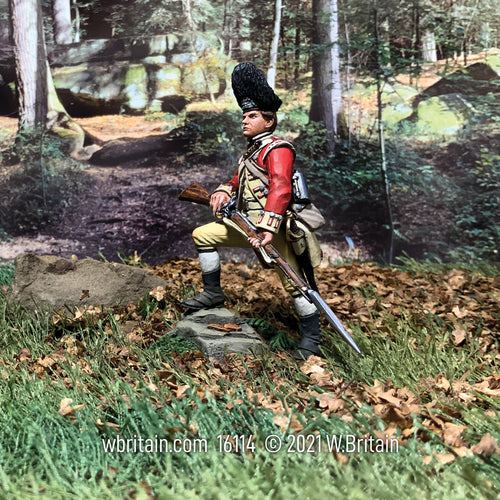 Collectible toy soldier 52nd regiment of foot. He is standing in a field holding a musket and bayonet.